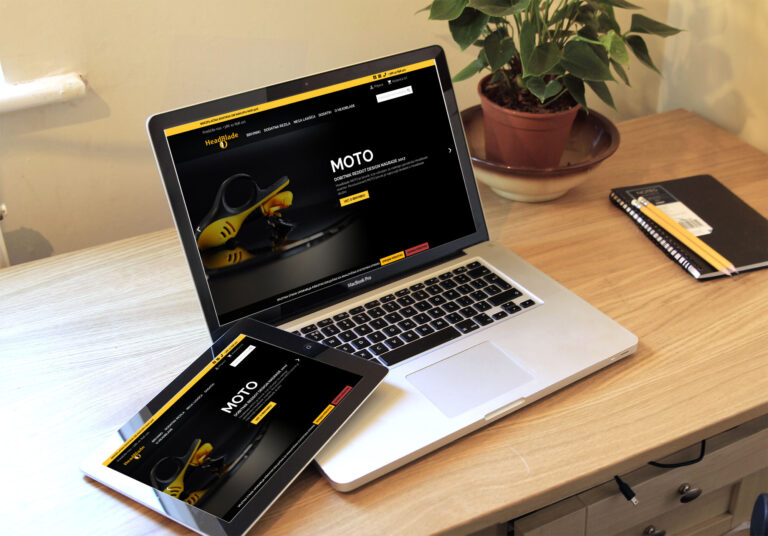 Spletna stran HeadBlade.si prikazana na zaslonu prenosnega računalnika in telefona.